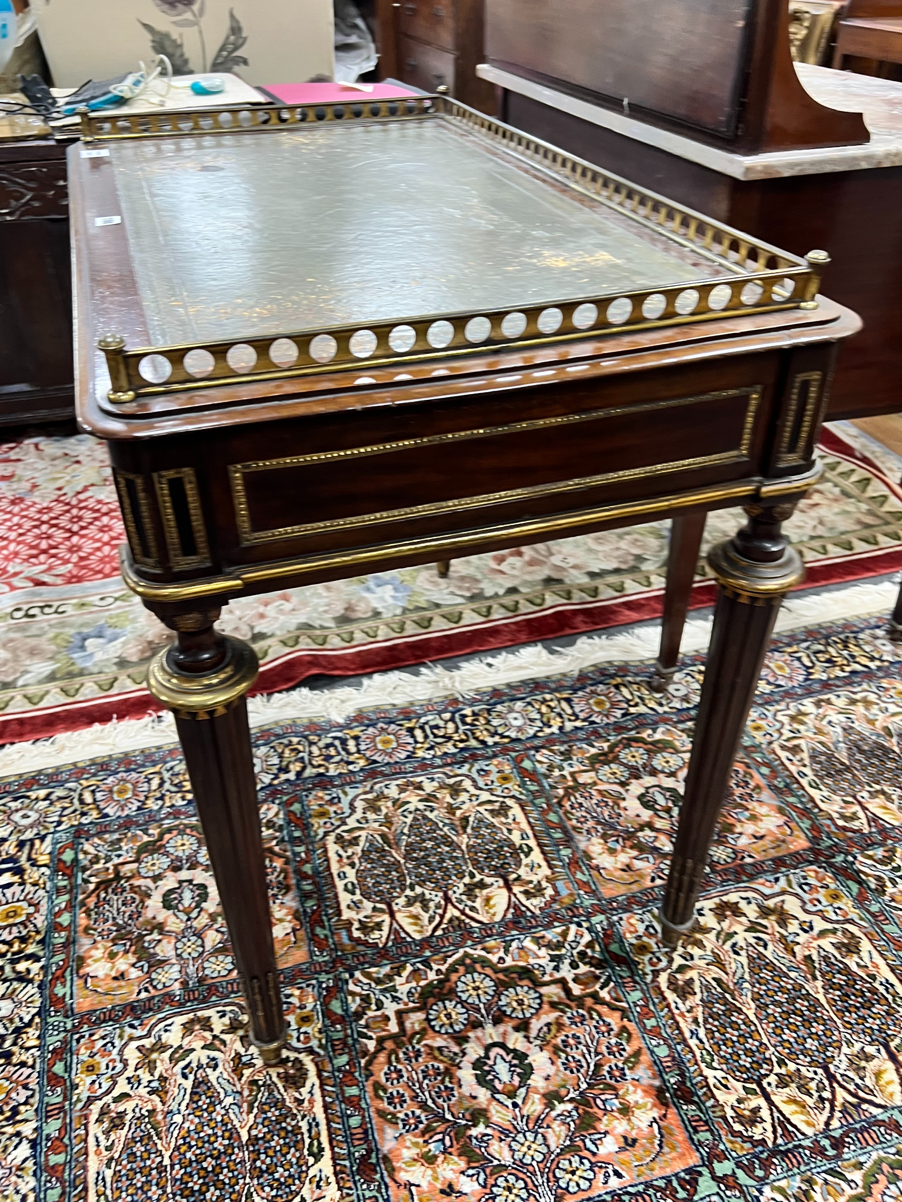 A late 19th century French ormolu mounted mahogany two drawer writing table, width 94cm depth 55cm height 79cm
